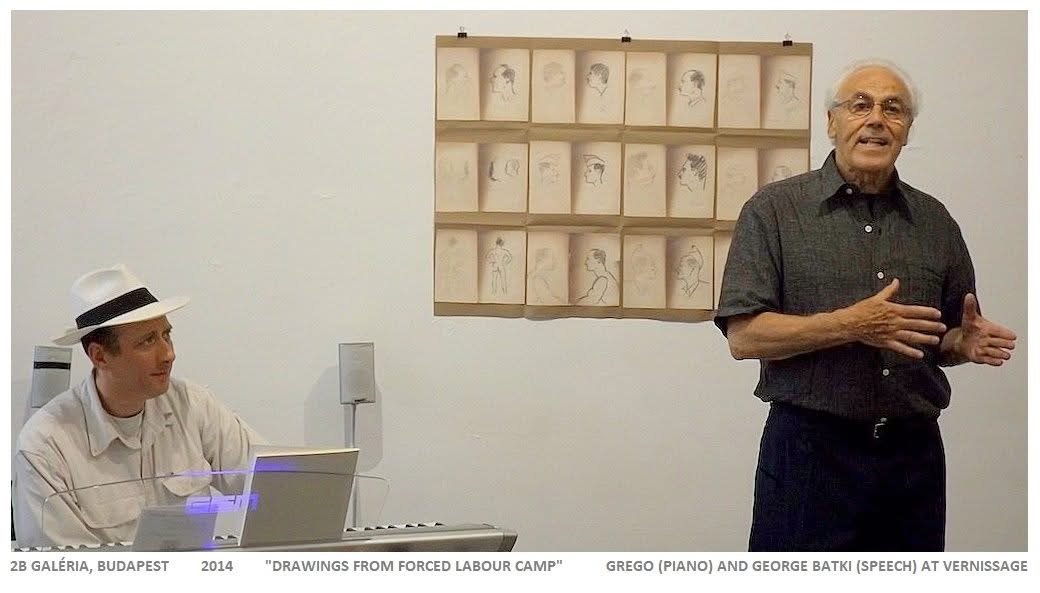 Grego at a keyboard while George Batki speaks beside a wall of pencil portraits