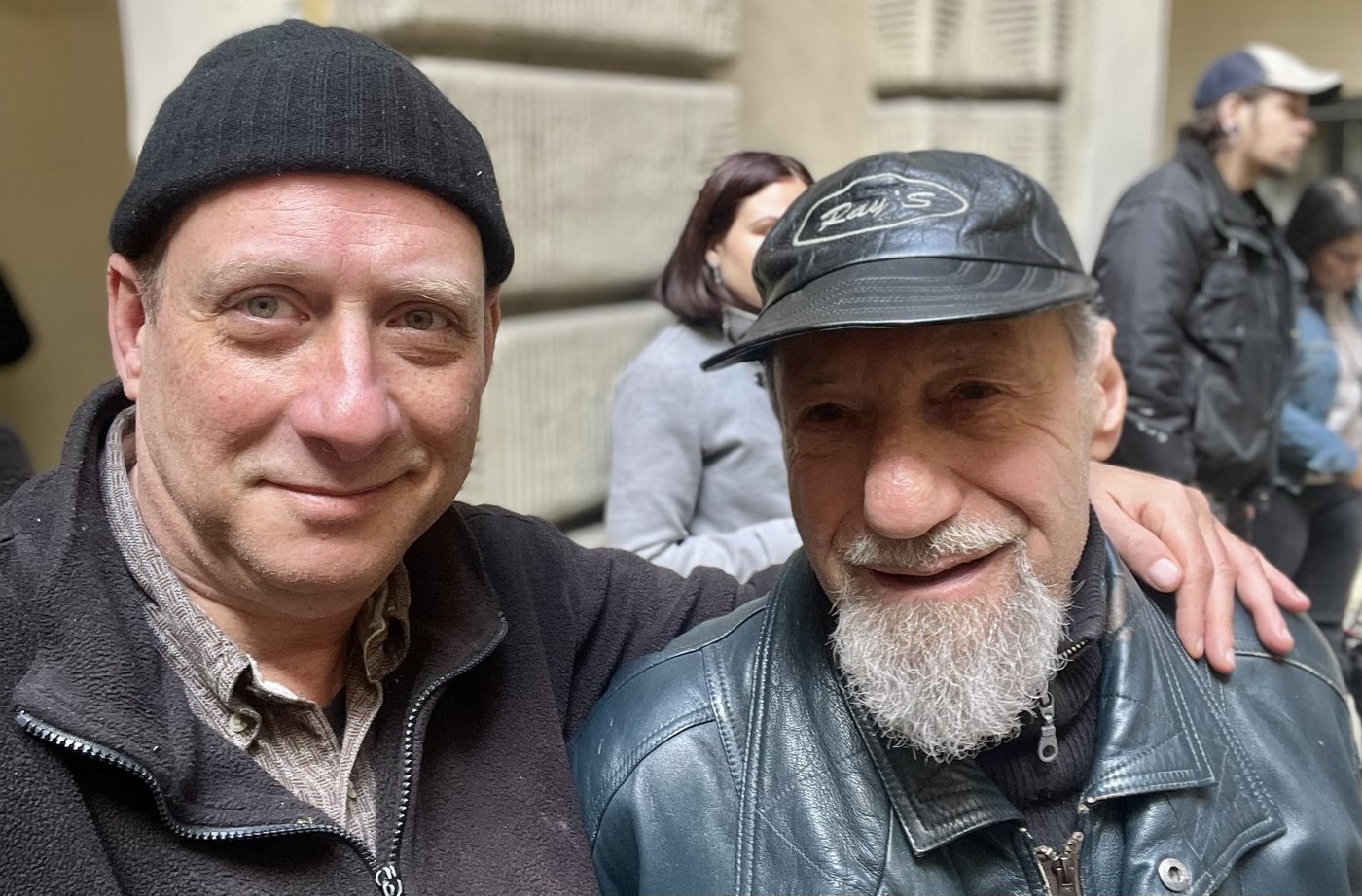 Grego with his arm around Tamás Berki in a street