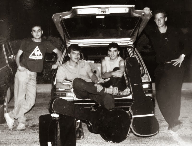 The Adi Salomon Jazz Quartet with their guitar cases around the open boot of a car at night