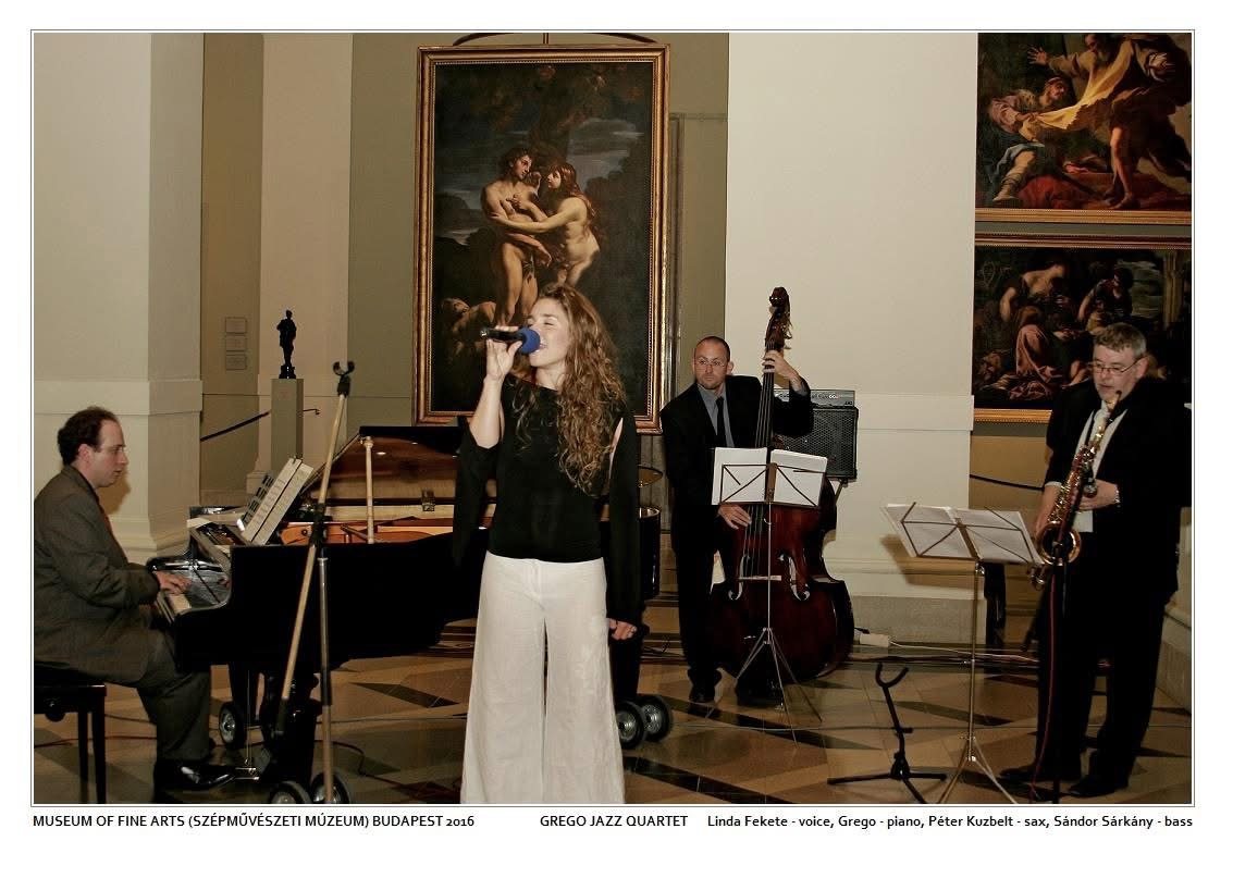 A jazz quartet playing beneath old master paintings in a museum hall