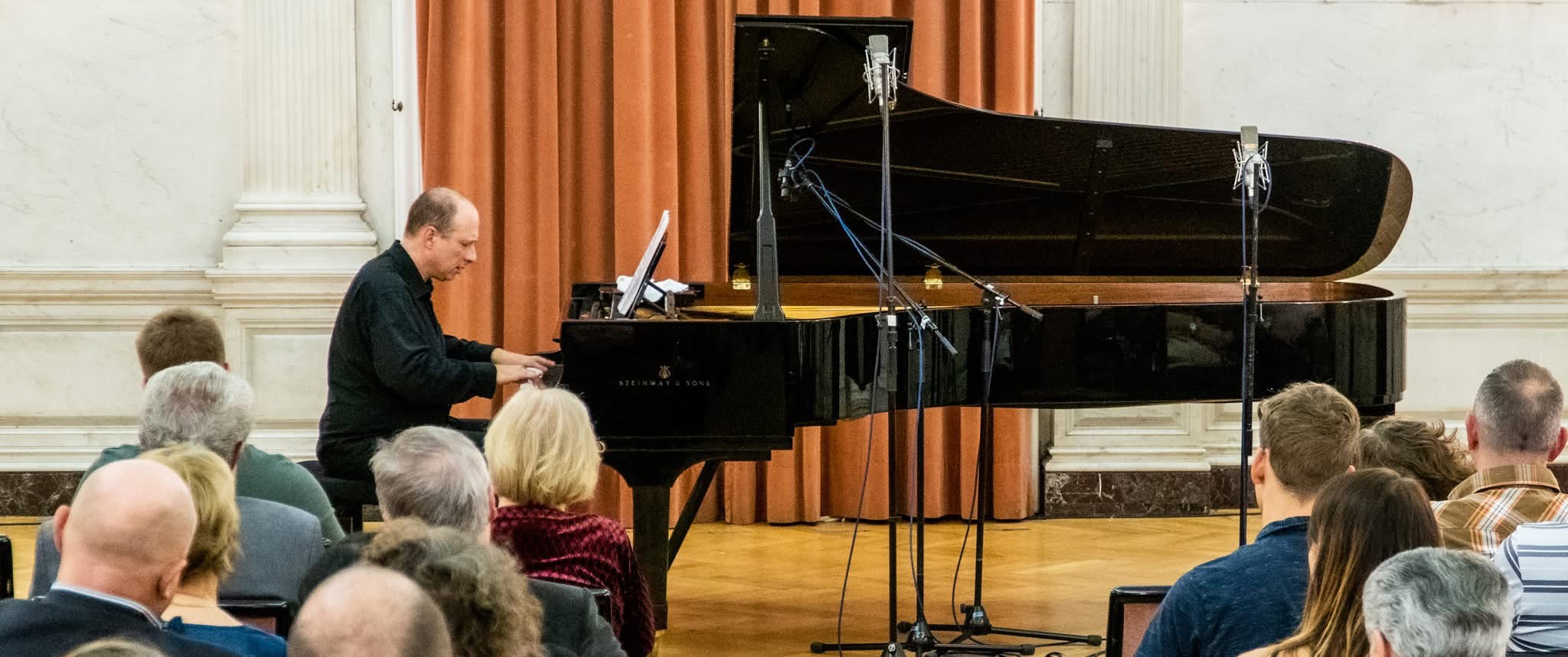 Grego playing the Steinway before the audience at the Márványterem