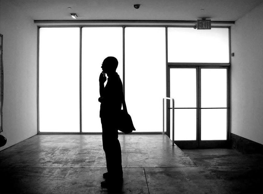 A figure silhouetted against a bright window