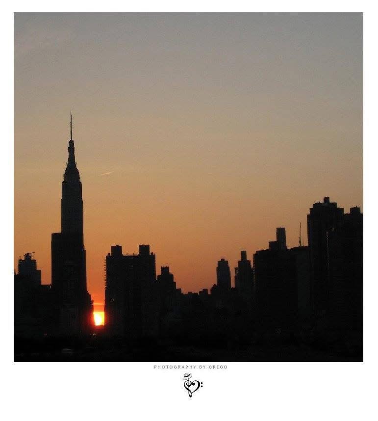 Manhattan skyline in silhouette at sunset with the Chrysler Building