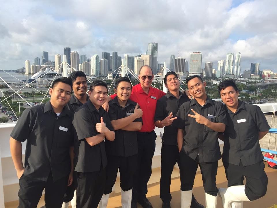 Grego with eight galley crew on deck, the Miami skyline behind